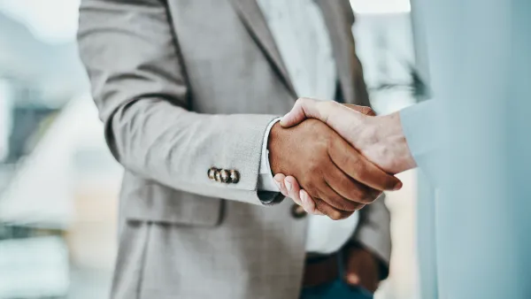 2 business people shaking hands