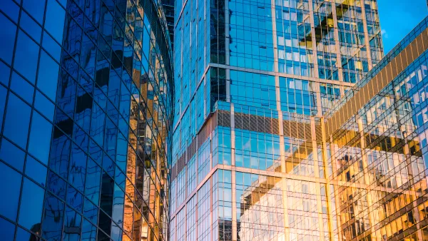 Tall buildings of glass and steel reflecting the glow of the setting sun in an urban setting