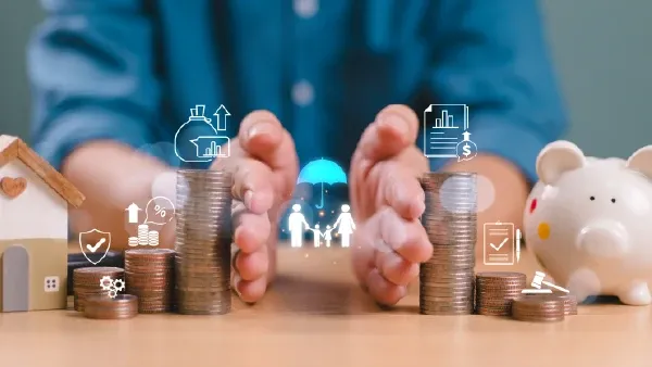 Table covered with coins and representations of compensation being pushed apart by a pair of hands that reveal an image of a family.