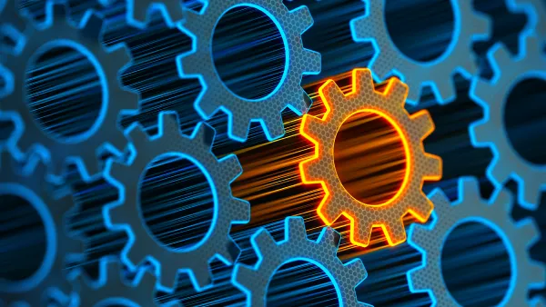 A graphic with interconnected gears made of blue light with a shining orange gear standing out from the rest