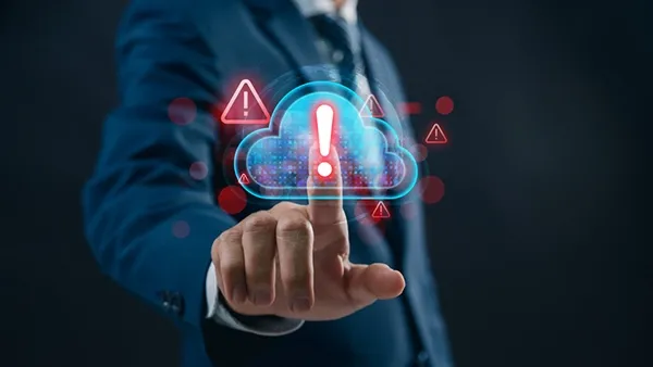 A business professional examines a cloud‑security alert on a digital dashboard, revealing overlooked compliance risks and warning indicators that highlight gaps IT teams often miss in cloud governance and data protection.