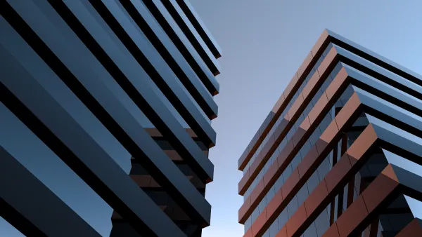 2 high rise buildings against a blue sky