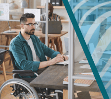 Professional sitting at desk in office working on computer